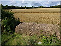 Field entrance blocked by a bale of hay