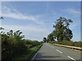 SP5667 : A361 (Ashby Road) with trees in a shallow valley by David Smith