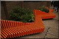 View of orange benches next to No. 1 London Bridge from Tooley Street