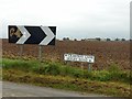 Arrow board and road name sign