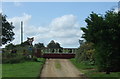 Train passing level crossing near Warham St Mary Railway Halt