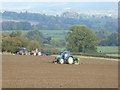 SO4388 : Tractors on the ploughsoil near Whittingslow by Jeremy Bolwell