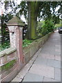 Stone post in front of Newton Mews with a bench mark