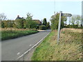 TL4532 : Footpath sign and minor road by Keith Evans