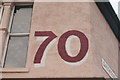 View of "70" painted above Menagerie Makes on Hoe Street