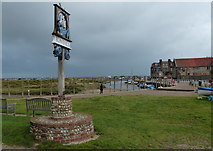 TG0244 : Blakeney village sign and small green by Mat Fascione
