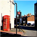 Red phonebox on a Neston corner