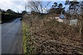 Road passing a house below Tor Hole