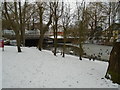 Part-frozen River Colne by road bridge to industrial Estate