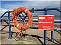 A Lifebelt hangs on the railings at Spittal Promenade