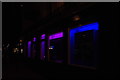 View of blue and pink lights inside Contrasti Hair and Beauty from Praed Street