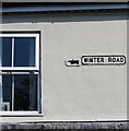 Road name sign on a house in Winter Road