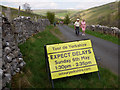 SD9772 : Sign warning of delays due to the Tour de Yorkshire by Stephen Craven