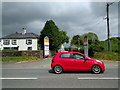 Red car passing Fatherford Farm Units