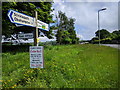 Road sign on the old A30 near Sticklepath, looking east