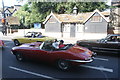 View of an E-Type Jaguar waiting at the traffic lights at Eltham Church on Well Hall Road