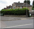 Two telecoms cabinets and a hedge on a suburban corner, Cheltenham