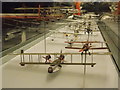 View along a case of model planes in the RAF Museum