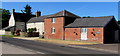 Brick buildings and a stone house, Chepstow Road near Raglan