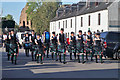 A marching pipe band in Beauly