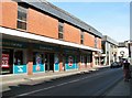 Magdalen Street past a large Poundland shop (closed)