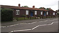 Wooden single-storey houses, Farm Road, Street, Somerset