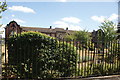 View of Sir George Monoux Sixth Form College and the railings matching up from Chingford Road