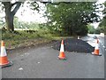 SO9818 : Pile of tarmac on the A436, Pegglesworth by David Howard