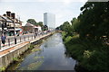 View along the River Wandle towards Colliers Wood from the bridge leading to Sainsbury