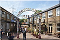 View of the Merton Abbey Mills arch from Watermill Way