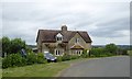 Semi-detached cottages on a bend near Woolas Hall