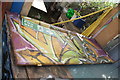 View of street art painted on a wooden door in the Nomadic Community Garden