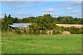 Farm buildings beside course of Roman road