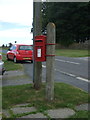 NZ1131 : Elizabeth II postbox on Saunders Avenue, Hamsterley by JThomas