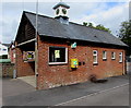 Yellow defibrillator box and a public clock, Market Place, Pewsey