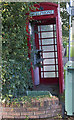 A derelict phone box without a door or phone