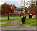 Two telecoms cabinets and a postbox on an Usk corner