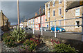 Sunlit houses beyond sturdy railings