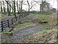 Paving around the village spring, East Carlton