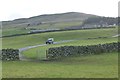 A Landrover comes down the track from Low Oxnop