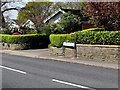 Walls, hedges and a bilingual name sign, Henfaes Road, Tonna