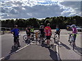 Cyclists resting at the entrance to Chepstow racecourse car park