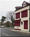 Shuttered premises and an old milepost, High Street, Nelson