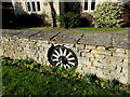 Old wagon wheel in a Haresfield wall