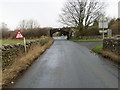 Road passing under a railway bridge to reach the A65 near Gildersleets