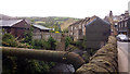 SE0125 : Pipe and cabins over the Cragg Brook, New Road, Mytholmroyd by Phil Champion