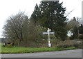 Signpost and rusty tractor at Powler