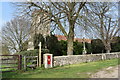 TM1935 : Postbox and churchyard, Harkstead by Simon Mortimer