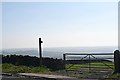 Fingerpost by a gate