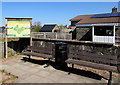 Benches, bin and board near the village hall, Bwlch, Powys